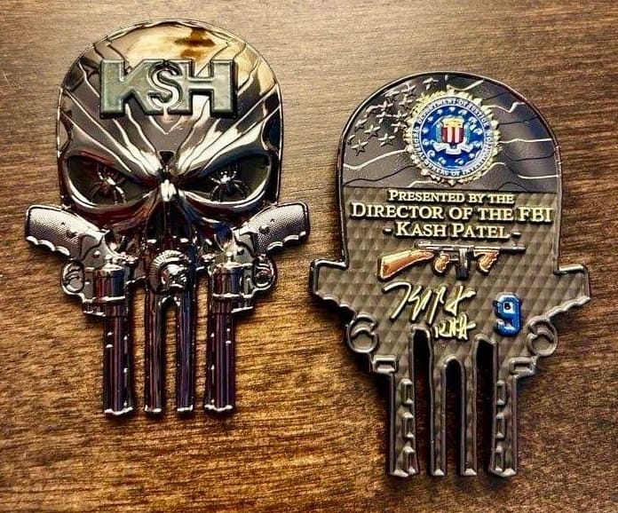 Photo of both sides of Patel's newest challenge coin, which are lying on a wooden surface. There are too many details to describe in alt text, but they are fully described in the rest of the text.